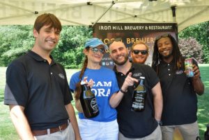 Monica Carr, CORA's Speech Therapist, visits with the Iron Hill Brewery Tent